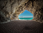 02457_旅游度假素材设计旅游者坐在阴凉的心形山洞里欣赏着湛蓝的天空碧绿的大海.jpg.jpg