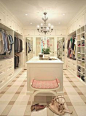 Fabulous his and hers closet, large island, mirrored doors, carpet. What a dream closet.