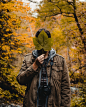 man holding green leaf covering his face