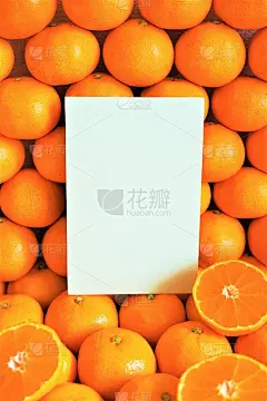 一个空白卡片的模型，上面有许多蜜橘的横截面，切好的橙子在一边竖着排列