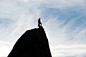 man standing on cliff under white sky photo – Free Sky Image on Unsplash