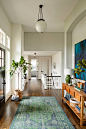 Large transitional dark wood floor hallway photo in Portland with white walls