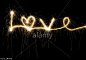 LOVE written with a sparkler at night including a heart shape. © Tim Gainey / Alamy