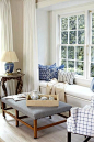 Blue and white living room with window seat - Interior Design by Carrier and Company: 