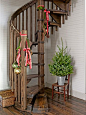 Hang velvet ribbons, glass ornaments, and pinecones to brighten a staircase. #christmas #decor: 
