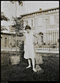 A woman in a garden with rake and baskets, Swatow