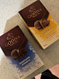 two boxes of godiva chocolates sitting on a counter