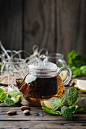 Hot black tea with lemon and mint on the wooden table