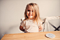 happy toddler girl having breakfast at home by Maria Kovalevskaya on 500px