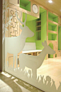 Adorable modern kids area. I love light wood with bright green and white!