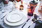  Elegant table with plates and glasses on white tablecloth