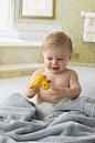 Caucasian baby boy playing with rubber duck