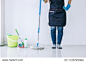Housekeeping and cleaning concept, Happy young woman in blue rubber gloves wiping dust using mop while cleaning on floor at home.