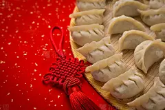 dumplings and Chinese kont on the red paper with white space