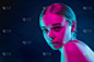 Portrait of female fashion model in neon light on 