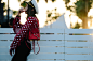 Woman wearing red polka dot jacket