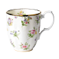 The 1920 Spring Meadow Mug is decorated with a motif of primroses, roses, violets, harebells and forget-me-nots on a subtle cream colored background, accented with 9-karat gold trim throughout.