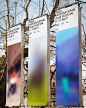 three large banners hanging from the side of a tree