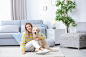 portrait-happy-woman-with-her-dog-home