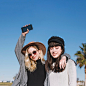 Stylish modern girls posing happily on street