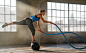 Loft Fitness Training : Fitness training in warehouse loft, athletes working with battled ropes and other training techniques. 