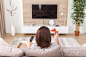 Single woman eating pizza and watching tv
