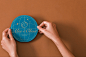 This may contain: two hands holding up a blue paper plate