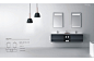 a bathroom with two sinks and three lights hanging from it's ceiling above the sink