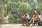 Young couple resting on pier near lake. Camping season