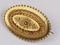 Ornate antique oval brooch, approx. 40mm x 25mm, comprising boat shaped centre with ornate applied