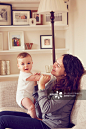 Mother and baby boy playing in living room