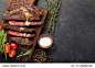 grilled ribeye beef steak with red wine, herbs and spices on a dark stone background. top view with copy space for your text