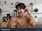 Asian man is smiling and expressing his happy feeling on the cellphone screen. He got good news and show his cheerful face. Technology could helped us have more convenience connection