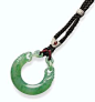 A JADEITE ARCHAISTIC DRAGON PENDANT, HUANG The half-hoop pendant of glassy pale green material, suffused with bright emerald green streaks, well carved in the form of an archaistic jade, huang, with a dragon-head emerging a loop at each end interlinked to