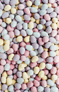 An overhead shot of dozens of candy chocolate mini Easter eggs