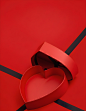 a-red-heartshaped-box-with-a-black-ribbon-on-a-bri (2)