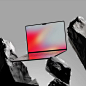 This may contain: an open laptop computer sitting on top of a rock formation with mountains in the background