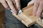 Men sandpaper grinds wood product in a workshop by Dmitriy Shmelev on 500px