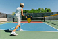 "Senior Woman Playing Pickleball On Court" by Stocksy Contributor "Raymond Forbes LLC"