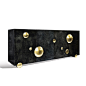 This spectacular couture style sideboard is manteled in goatskin. The pertruding solid brass hemispheres are forged by hand and finished with a light-brushed polished surface. The interior carries 1 adjustable glass shelf in each of the 3 sections. 

Fini