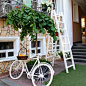 White Step Through Bicycle Leaning Beside Tree Plant