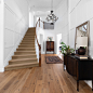 Foyer - large traditional medium tone wood floor, brown floor and wall paneling foyer idea in San Diego with white walls