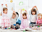 Kid with raised hands in the living room._创意图片