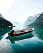 brown and white boat on lake during daytime