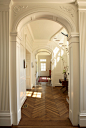 Mid-sized elegant medium tone wood floor hallway photo in Atlanta with white walls