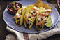 Preparing Mexican Tacos with Spicy Salsa and Shrimps