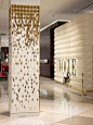 A specially designed diamond with an angled face was arrayed to convey falling golden gradients of colour in the studio’s third installation for the Dubai Mall. The columns are composed of ceramic tiles in both matt white and high gloss gold finish, angle