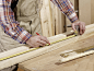 Detail of man marking piece of timber using pencil and tape measure by fStop_images on 500px