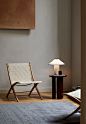 Photograph showing rattan and wooden chair by side table with lamp[主动设计米田整理]