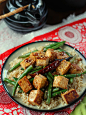 This flavorful garlic tofu stir-fry is made with crispy bits of pan-fried tofu served up with crispy green beans and drenched in Chinese garlic sauce.